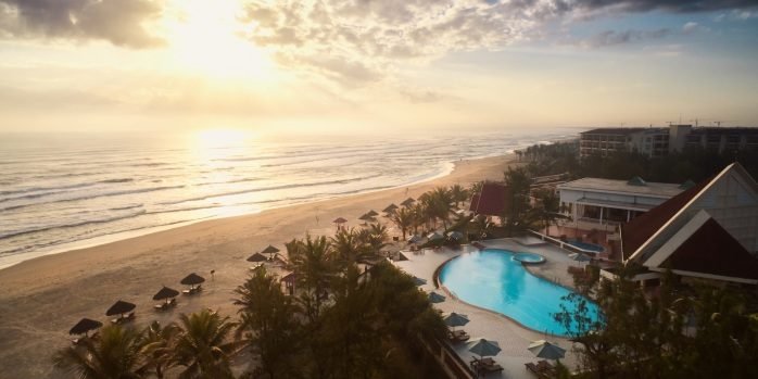 Aerial view of the Furama Resort's pool and My Khe Beach at sunset
