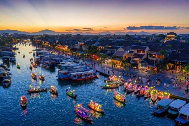 Lantern-lit boats on the Thu Bon River in Hoi An at dusk