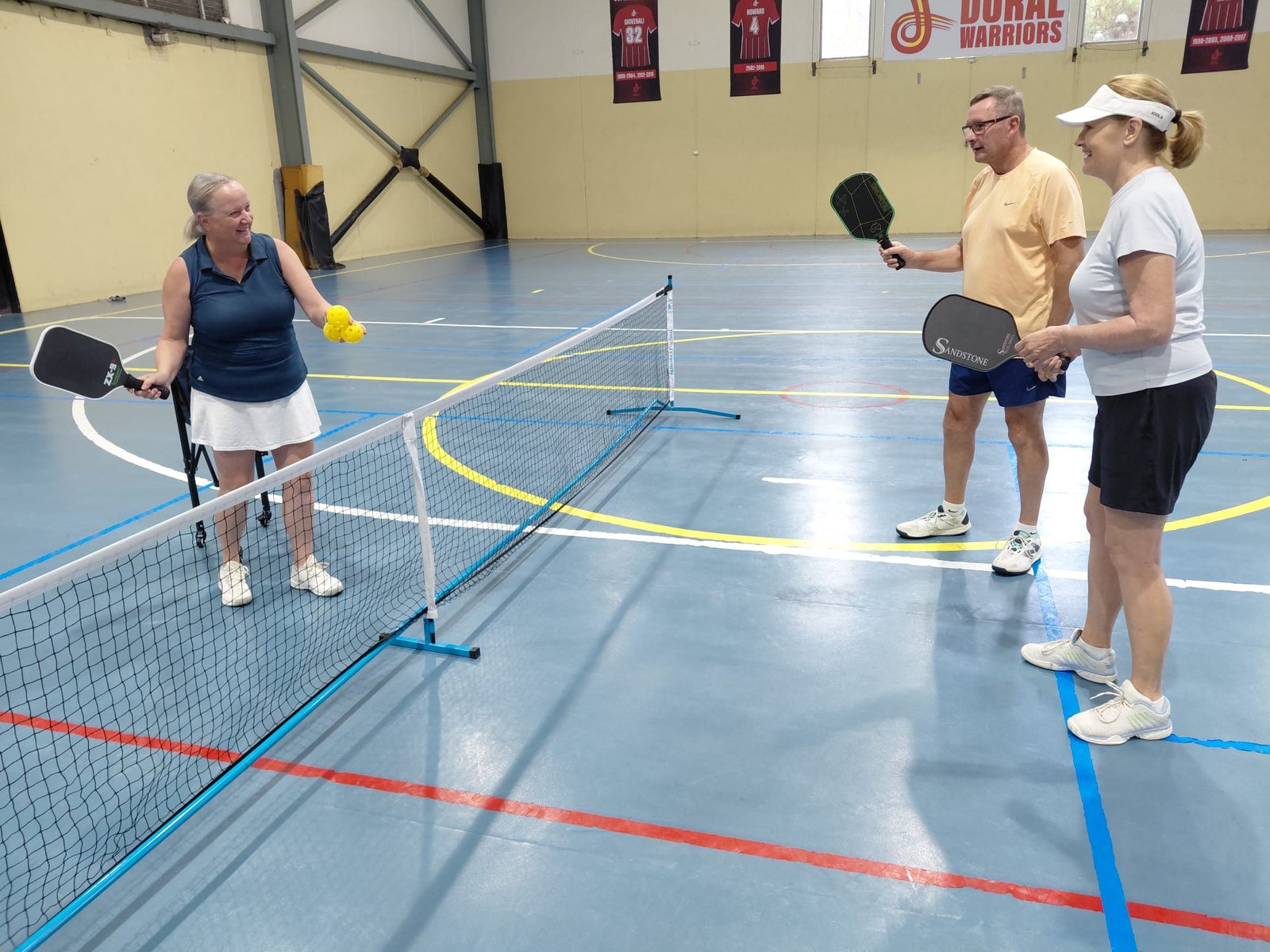 Kelley Keyes coaching pickleball players on court